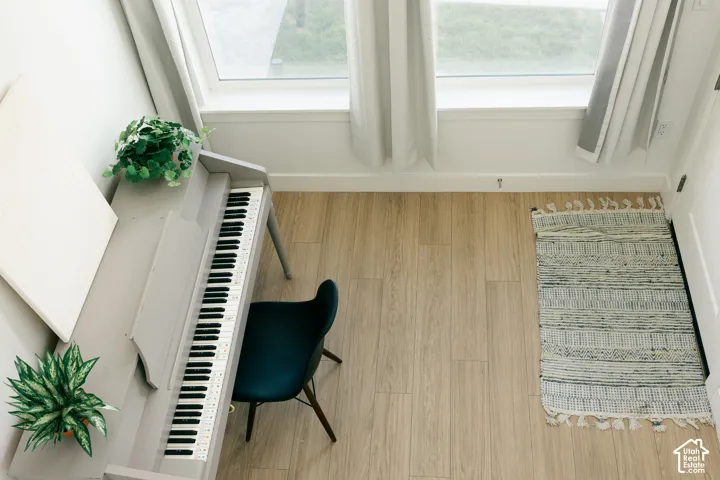 Wood-finish flooring with abundant natural light from large windows