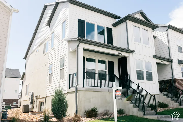 White siding exterior with black shutters and dark gray trim