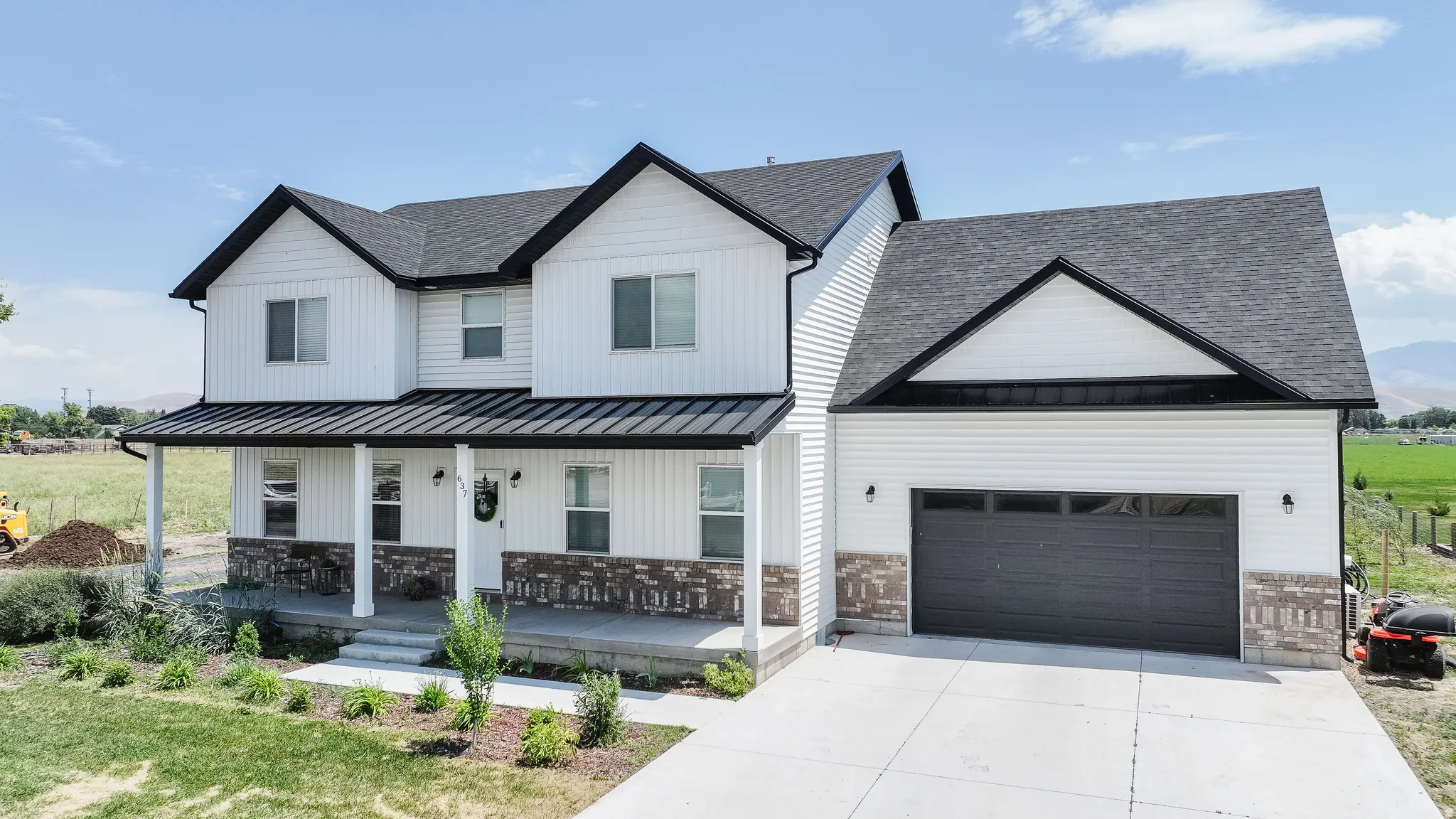 Two-story exterior with white siding and dark shingle roof