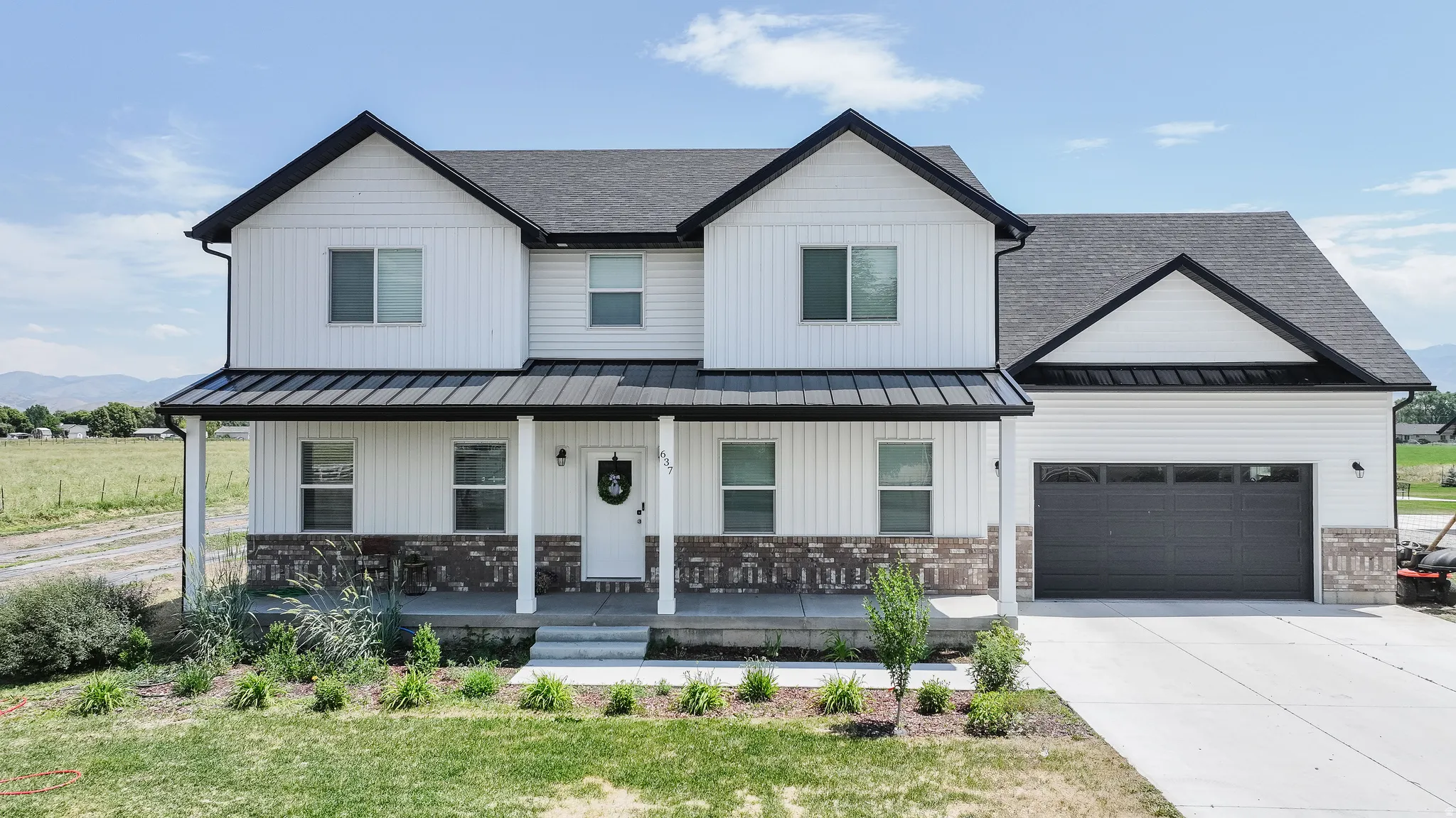White vertical and horizontal siding exterior with dark trim