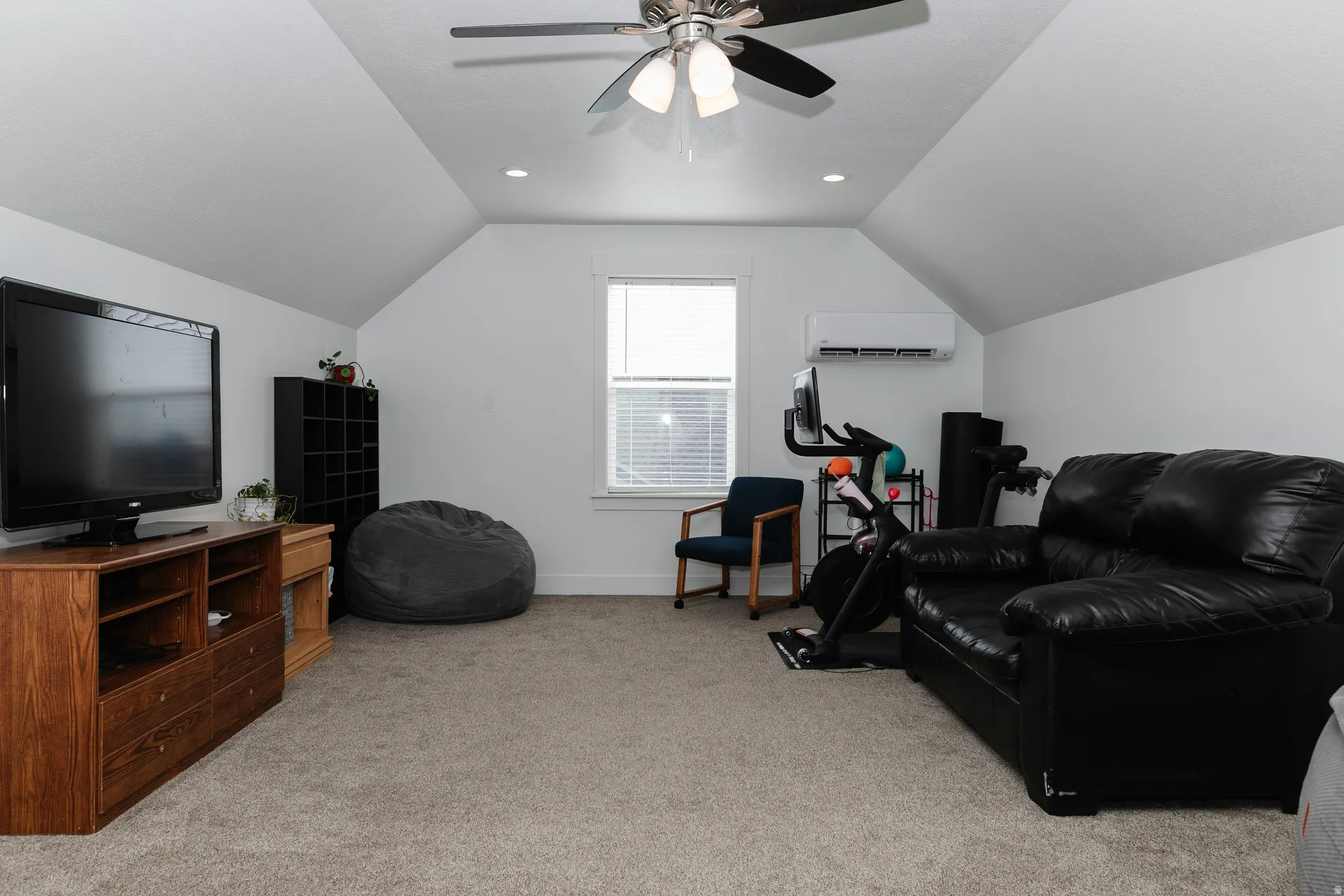 Carpeted room featuring a ceiling fan with integrated lighting, recessed lighting, and a single window