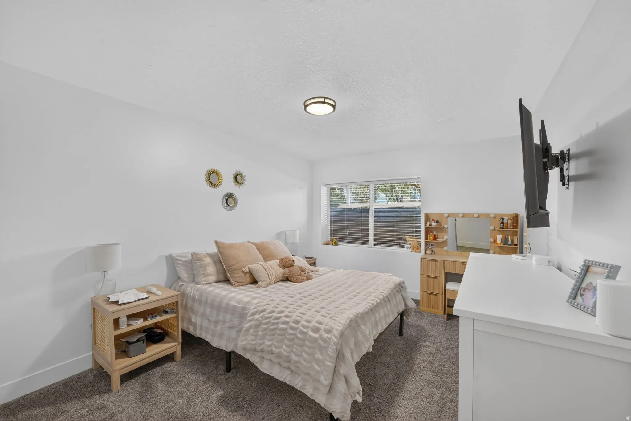 Window with horizontal blinds and an overhead flush mount light fixture
