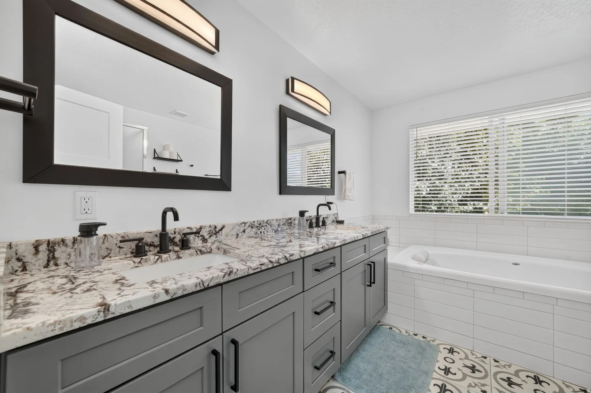 Dual vanity with stone countertops and undermount sinks