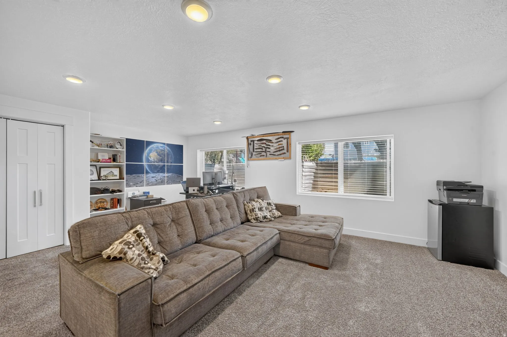 Recessed lighting, built-in shelving, and white bi-fold doors