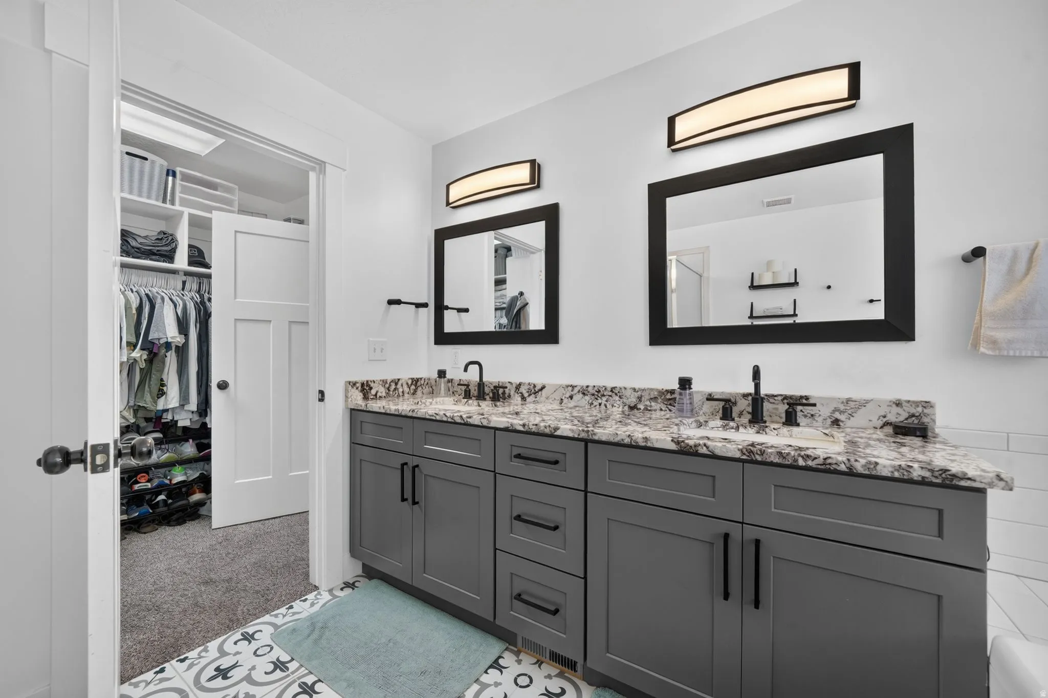 Dual vanity with stone countertop and matte black fixtures