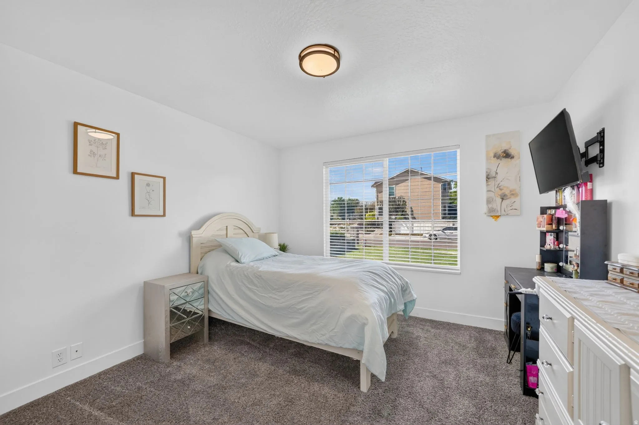 Recessed lighting, large window with blinds, and wall-mounted television bracket