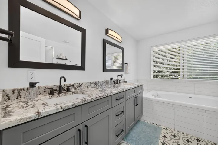 Dual vanity with stone countertops and undermount sinks