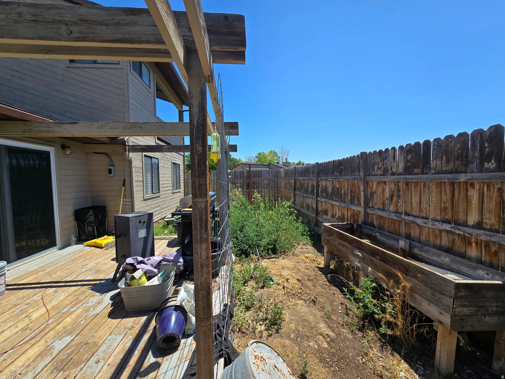 Wood deck with pergola structure and sliding glass door access