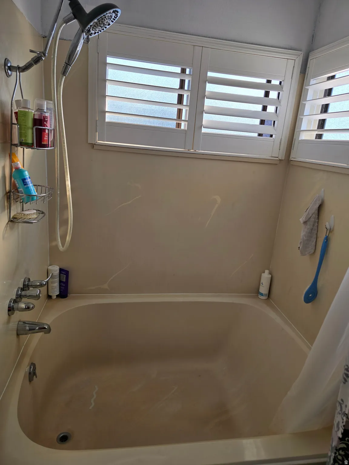 Bathtub and shower combination with chrome fixtures