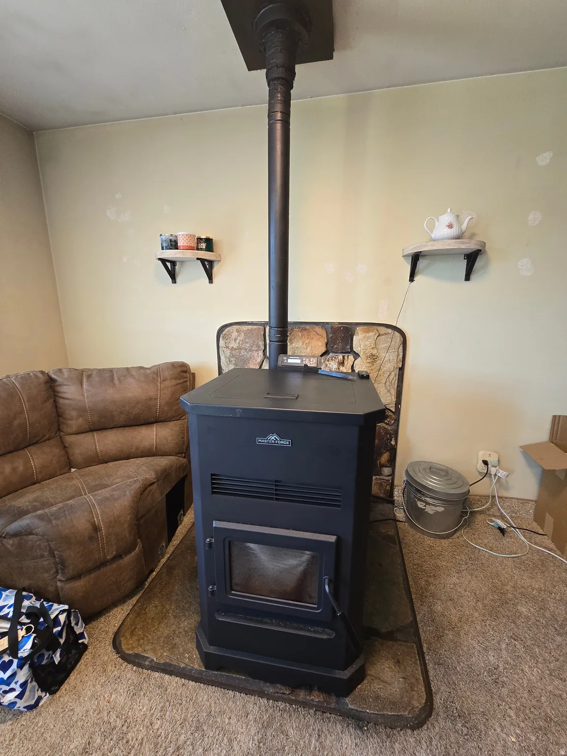Freestanding pellet stove with a visible firebox, positioned on a hearth