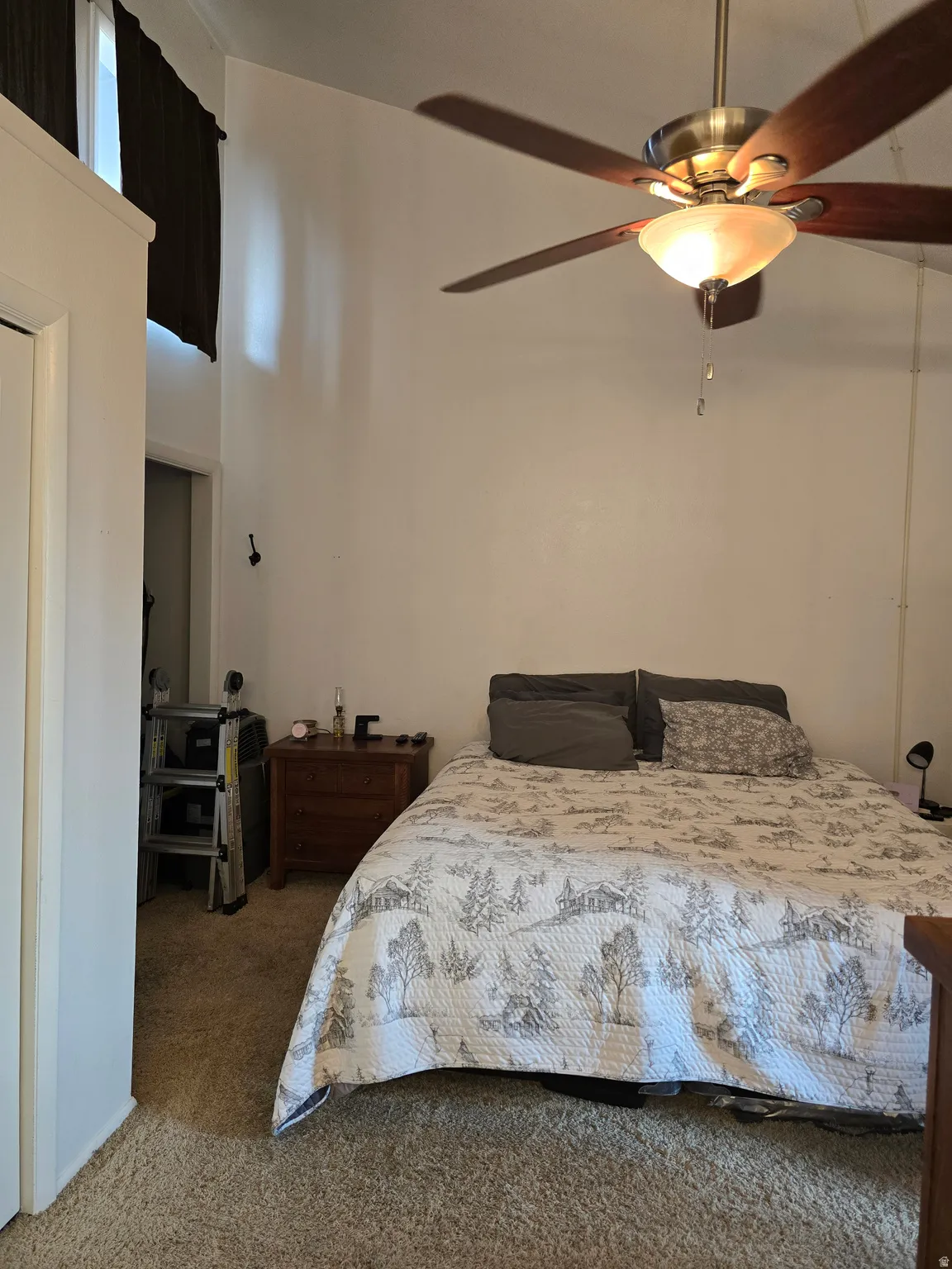 Integrated ceiling fan with light fixture, high ceilings, and plush carpet flooring