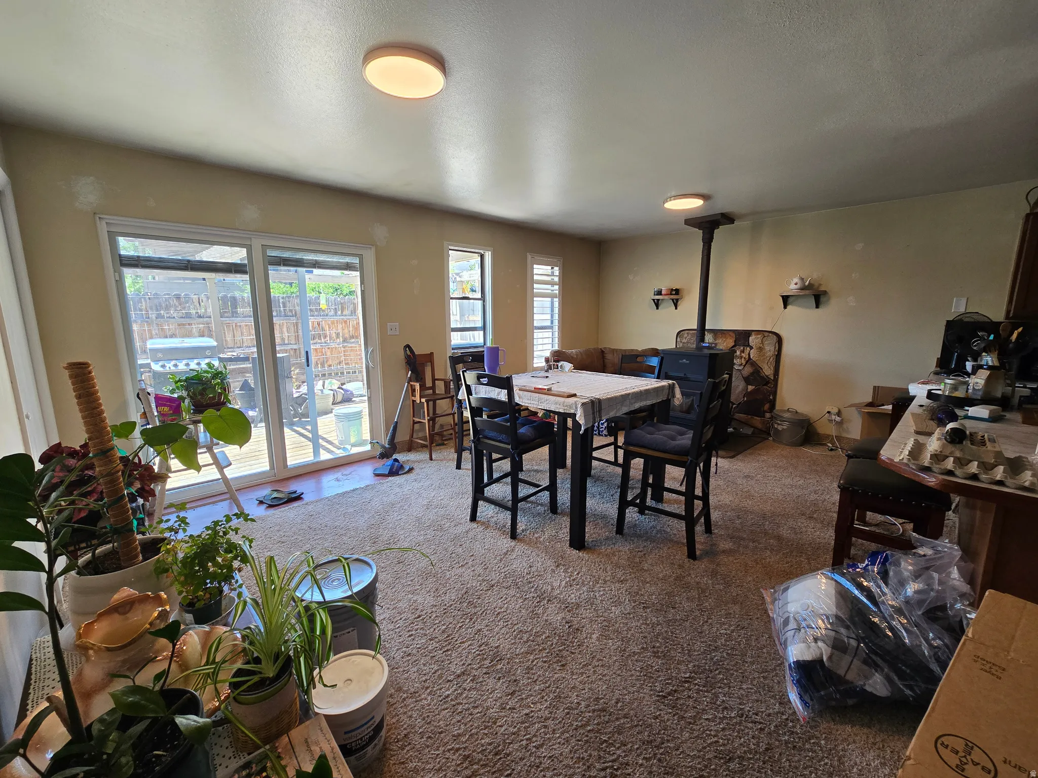 Sliding glass door, wood-finish flooring, recessed lighting, and wall-mounted shelving