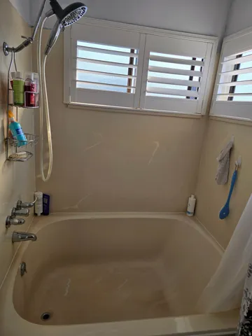 Bathtub and shower combination with chrome fixtures