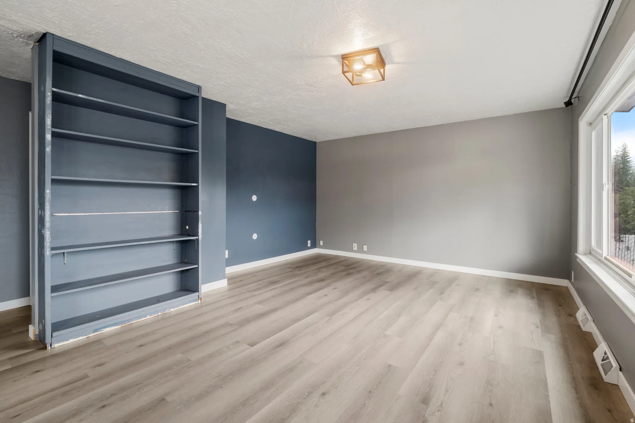 Light wood-finish flooring with a built-in shelving unit