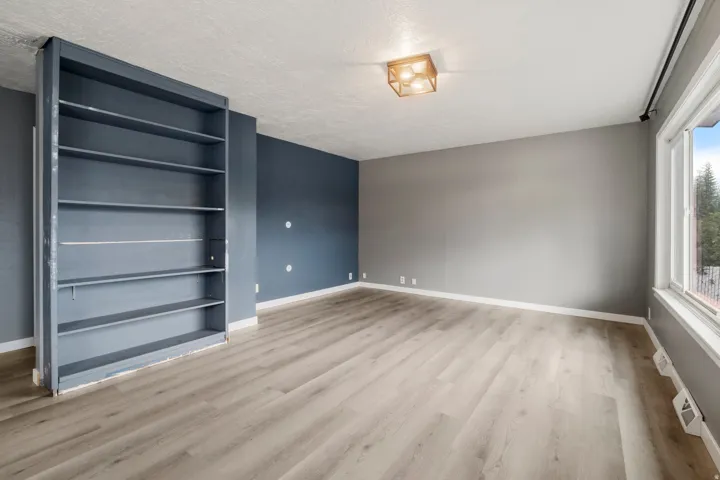 Light wood-finish flooring with a built-in shelving unit