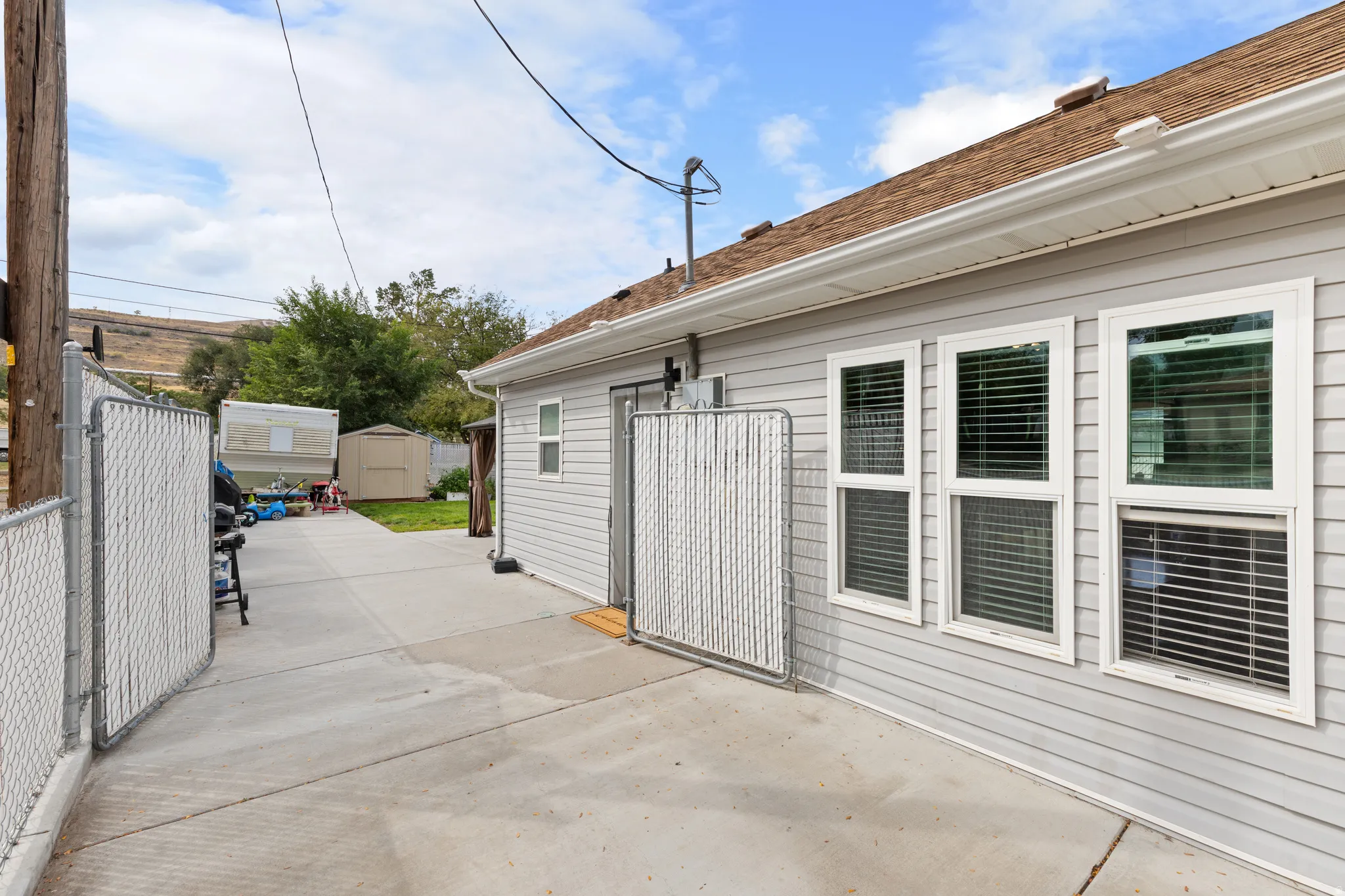 South side Windows. Behind the gate is Concrete RV Parking