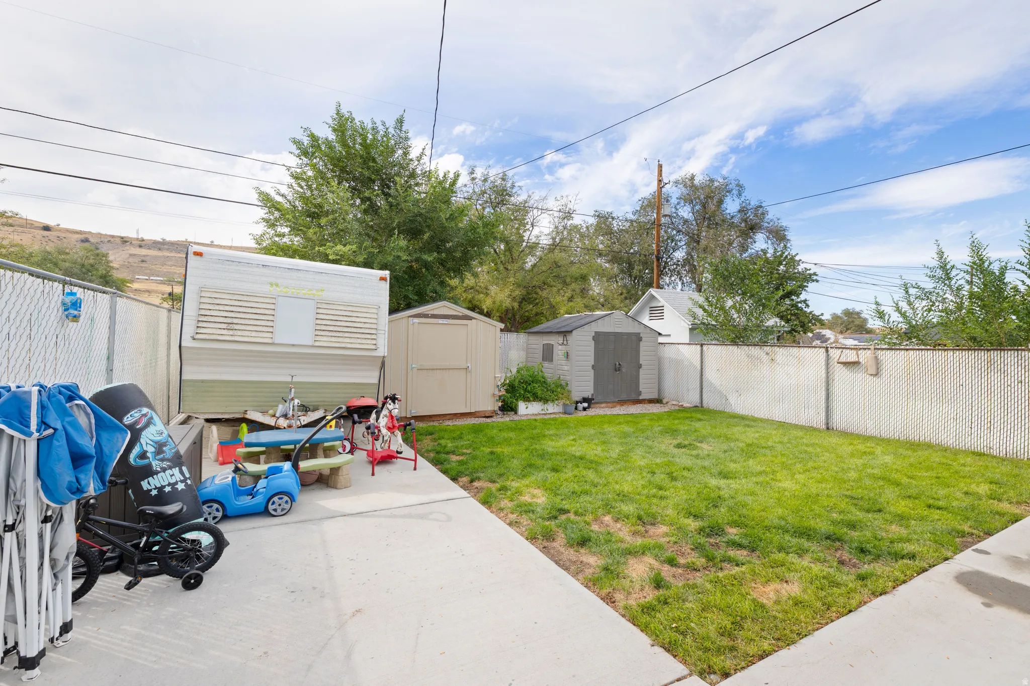 RV Parking. Grassy area. Fenced. Two Sheds.