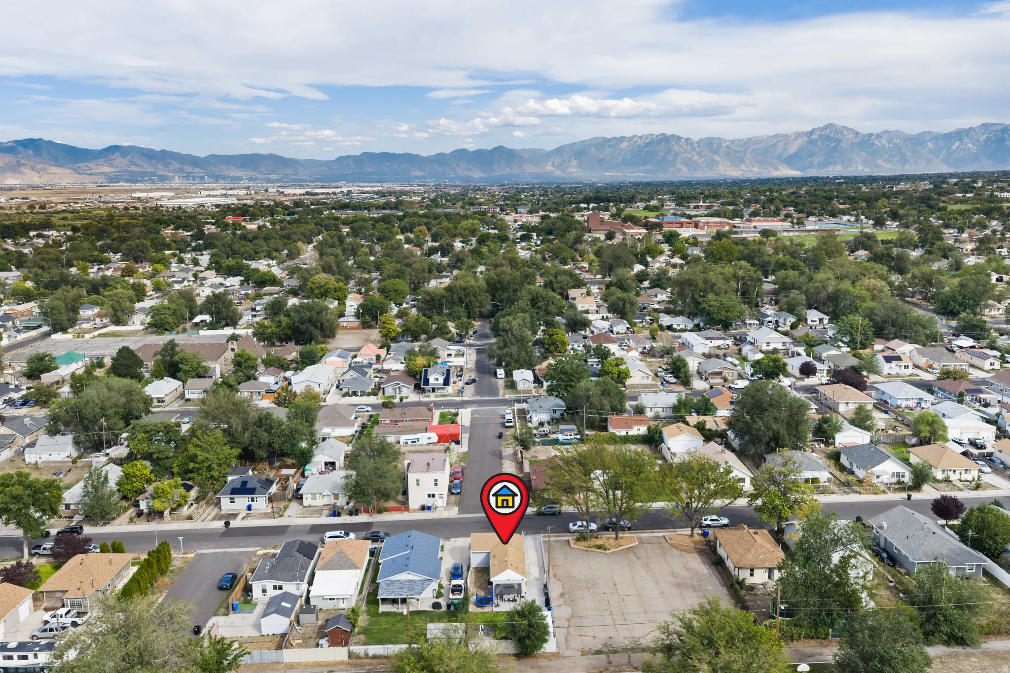 Expansive neighborhood setting with mature trees and mountain backdrops