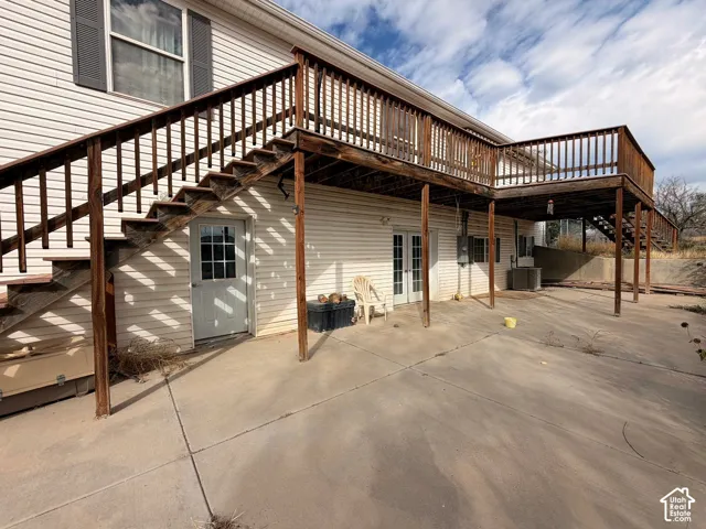 Extensive wood deck with railing and stairs, offering outdoor living space