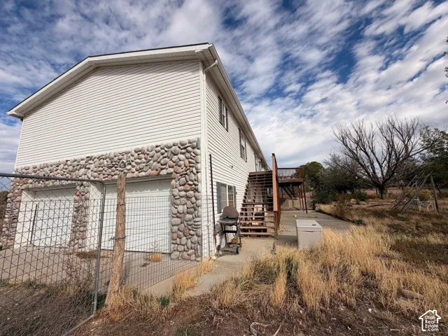 Two-story exterior with horizontal siding and a river rock stone facade
