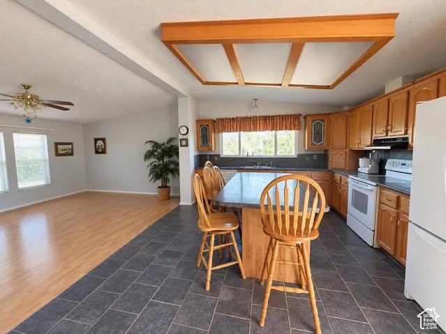 Kitchen featuring wood cabinetry, and tile flooring