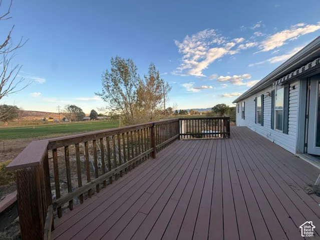 Expansive outdoor deck with wood-finish railing, composite decking, and direct access to the interior