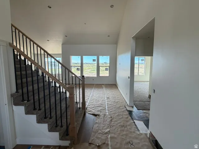 Staircase with wood-finish handrail and black metal balusters