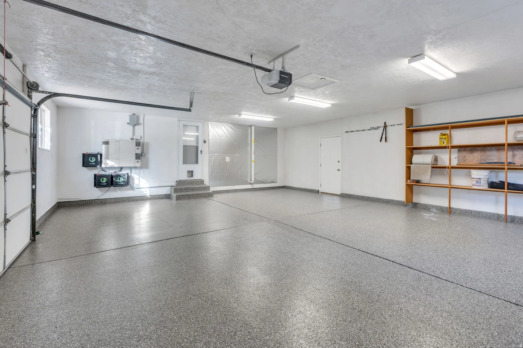 Extra Large Garage, New Epoxy-coated flooring, built-in shelving, overhead lighting, garage door, and entry door