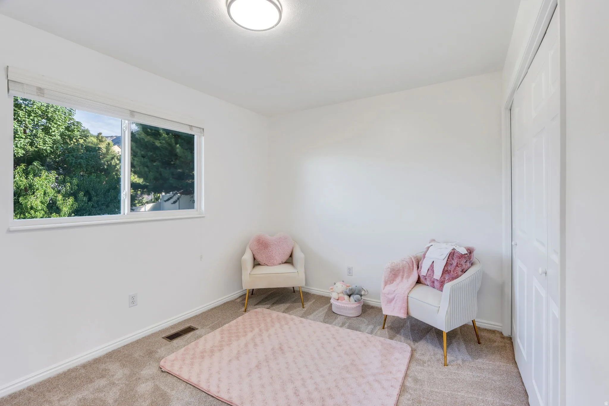Bedroom #2, near Primary Suite, new neutral wall paint, new carpeted flooring and a built-in closet with bifold doors