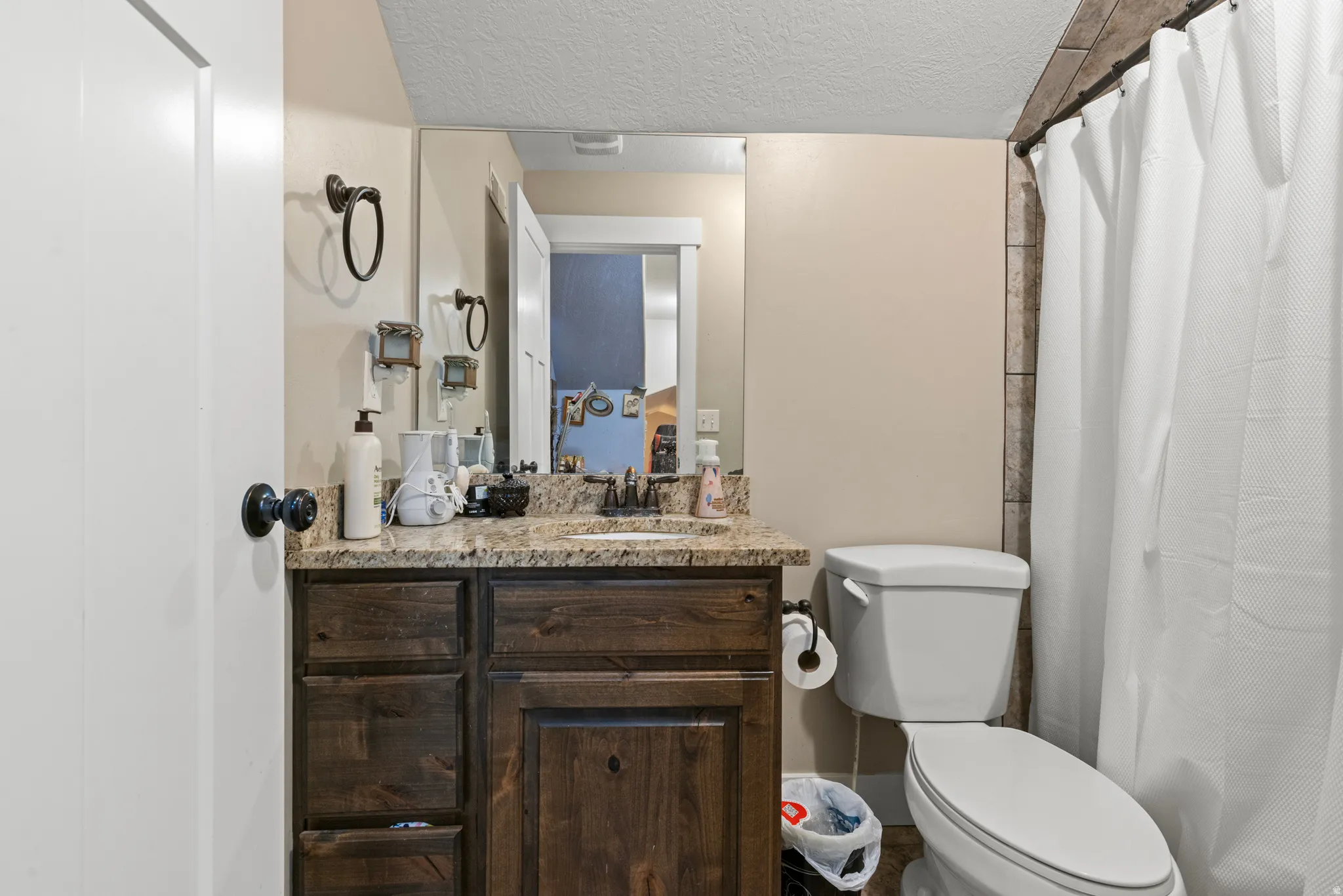 Wood-finish vanity with granite-style countertop