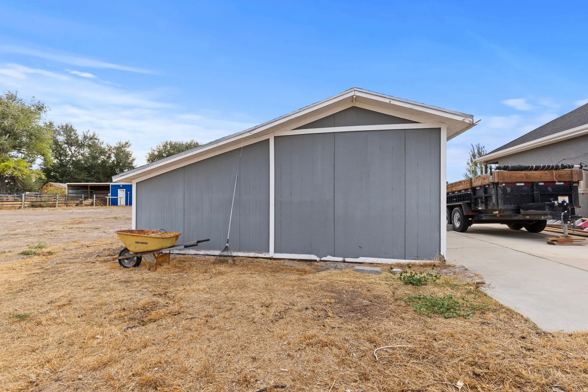 Detached storage building with a sloped roof and siding exterior