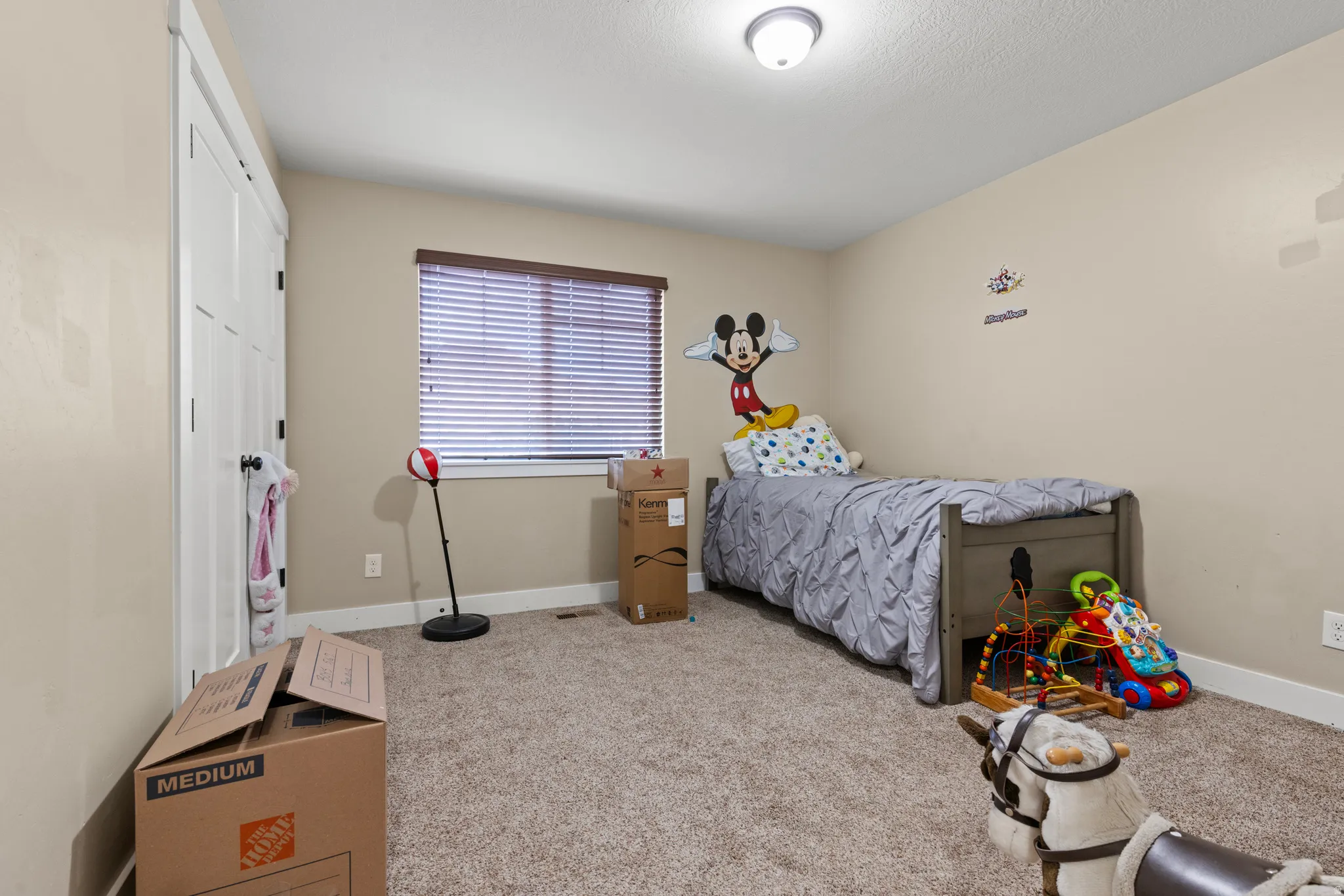 Carpeted flooring, window with blinds, and a flush mount ceiling light fixture