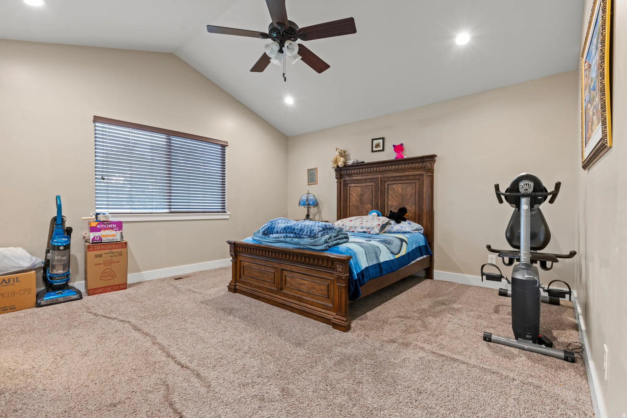 Vaulted ceiling, ceiling fan, recessed lighting, window with blinds, carpeted flooring