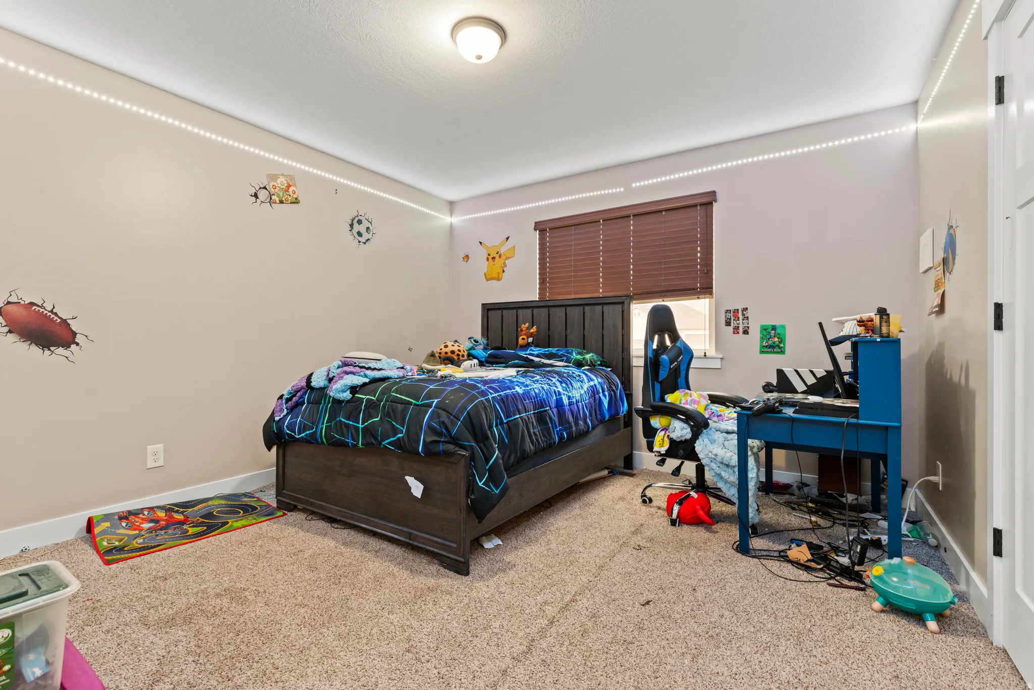 Carpeted room and a built-in overhead light fixture