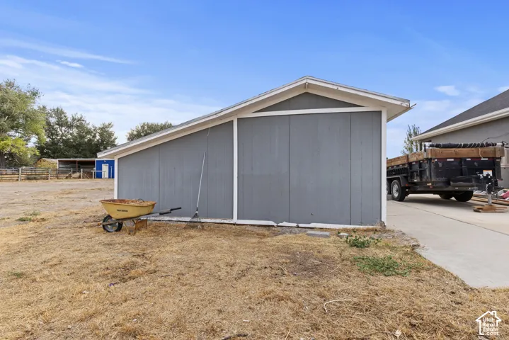 Detached storage building with a sloped roof and siding exterior