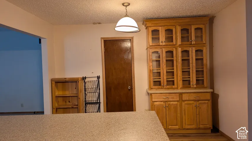 Custom built-in display cabinetry with glass fronts and lower storage, complemented by a light-toned countertop surface