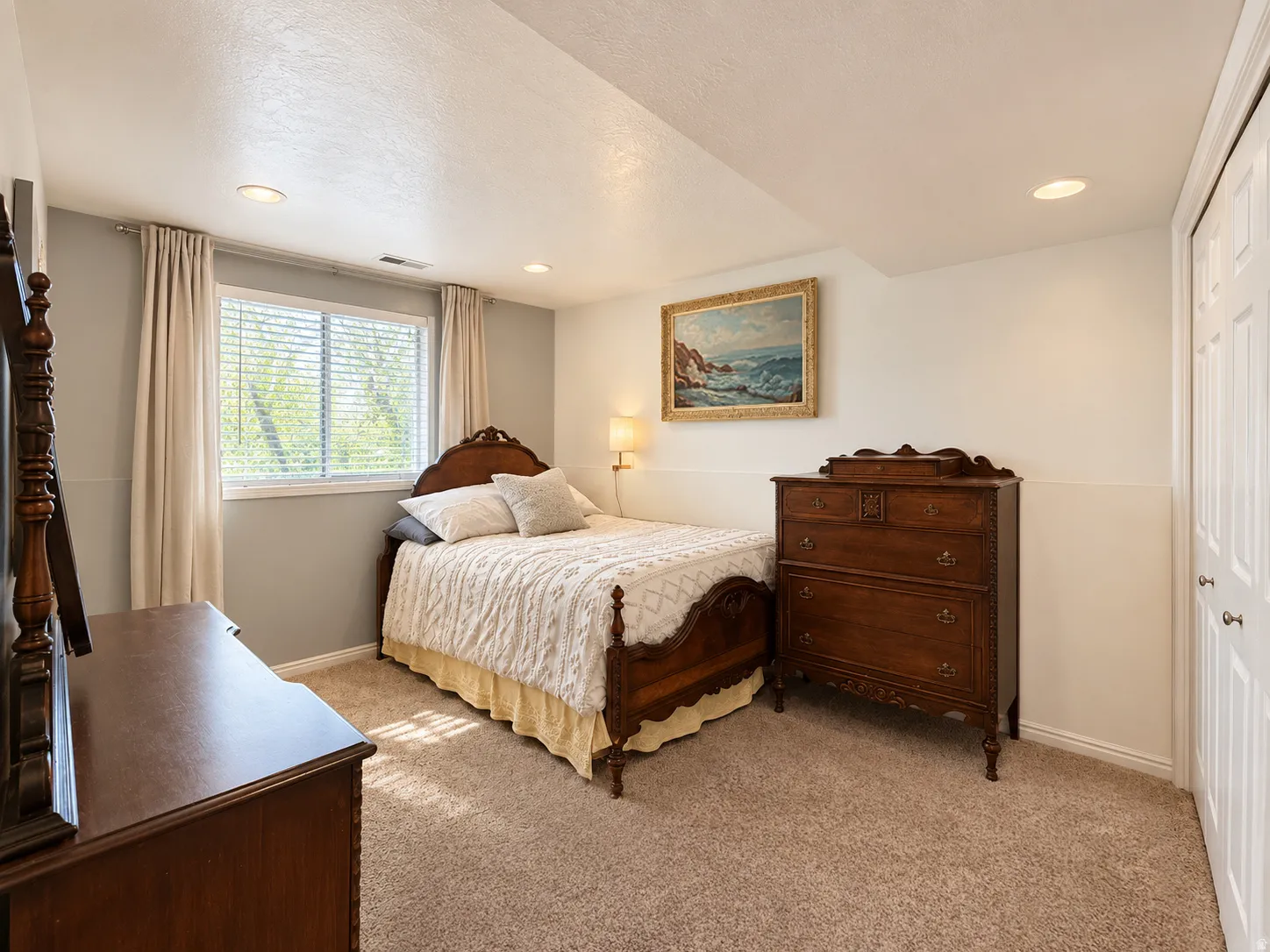 Wall-to-wall carpeting, recessed lighting, double-door closet, window with blinds