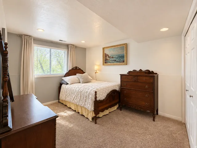 Wall-to-wall carpeting, recessed lighting, double-door closet, window with blinds