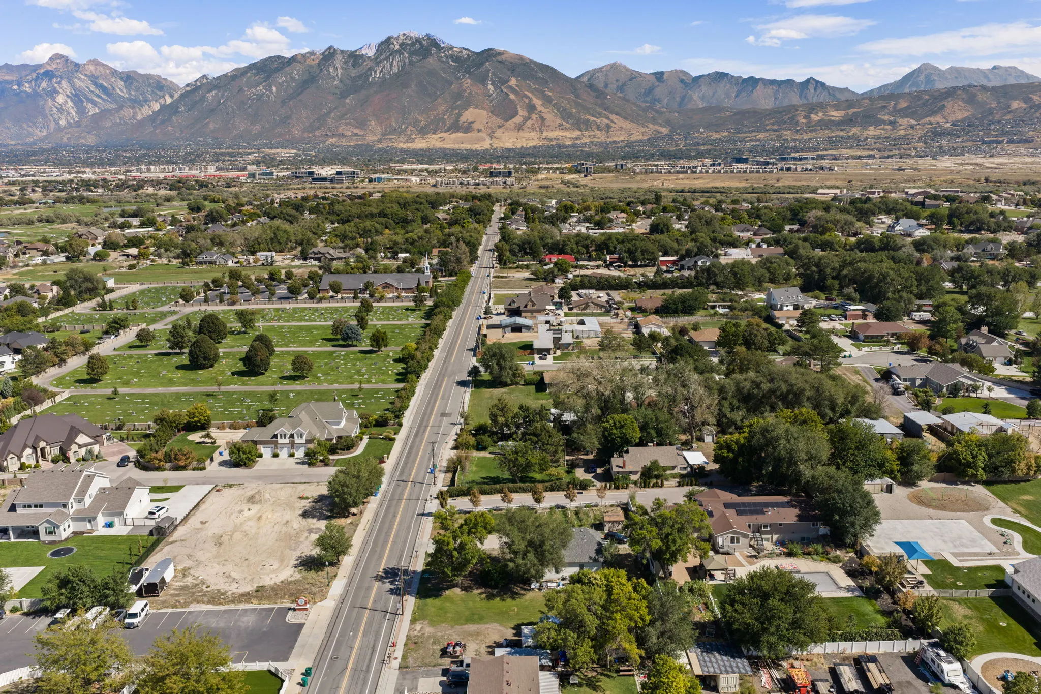 Aerial view showcasing this property's prime location within an established neighborhood, surrounded by mature landscaping and tree-lined streets