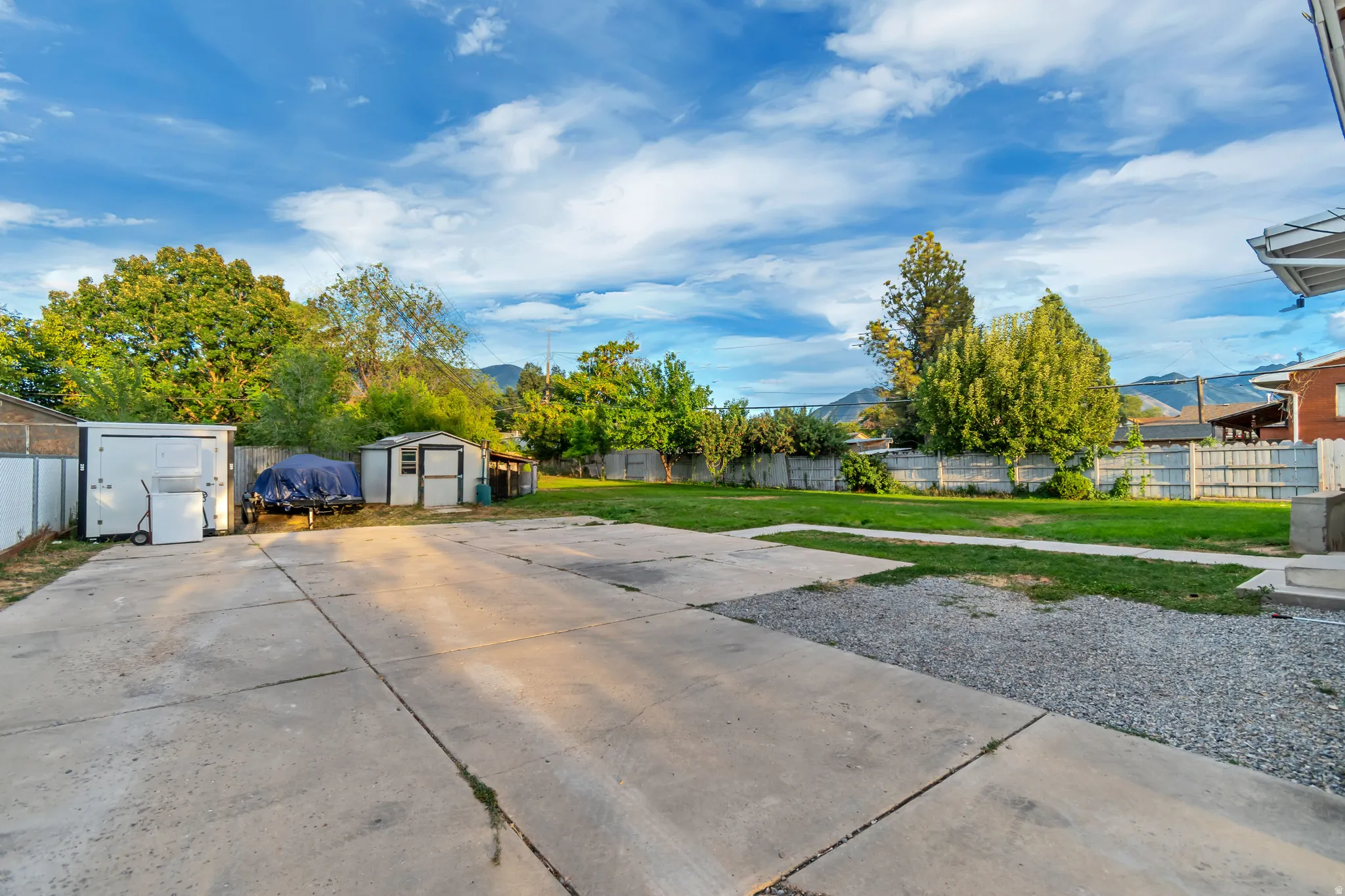 Expansive paved driveway with additional gravel parking