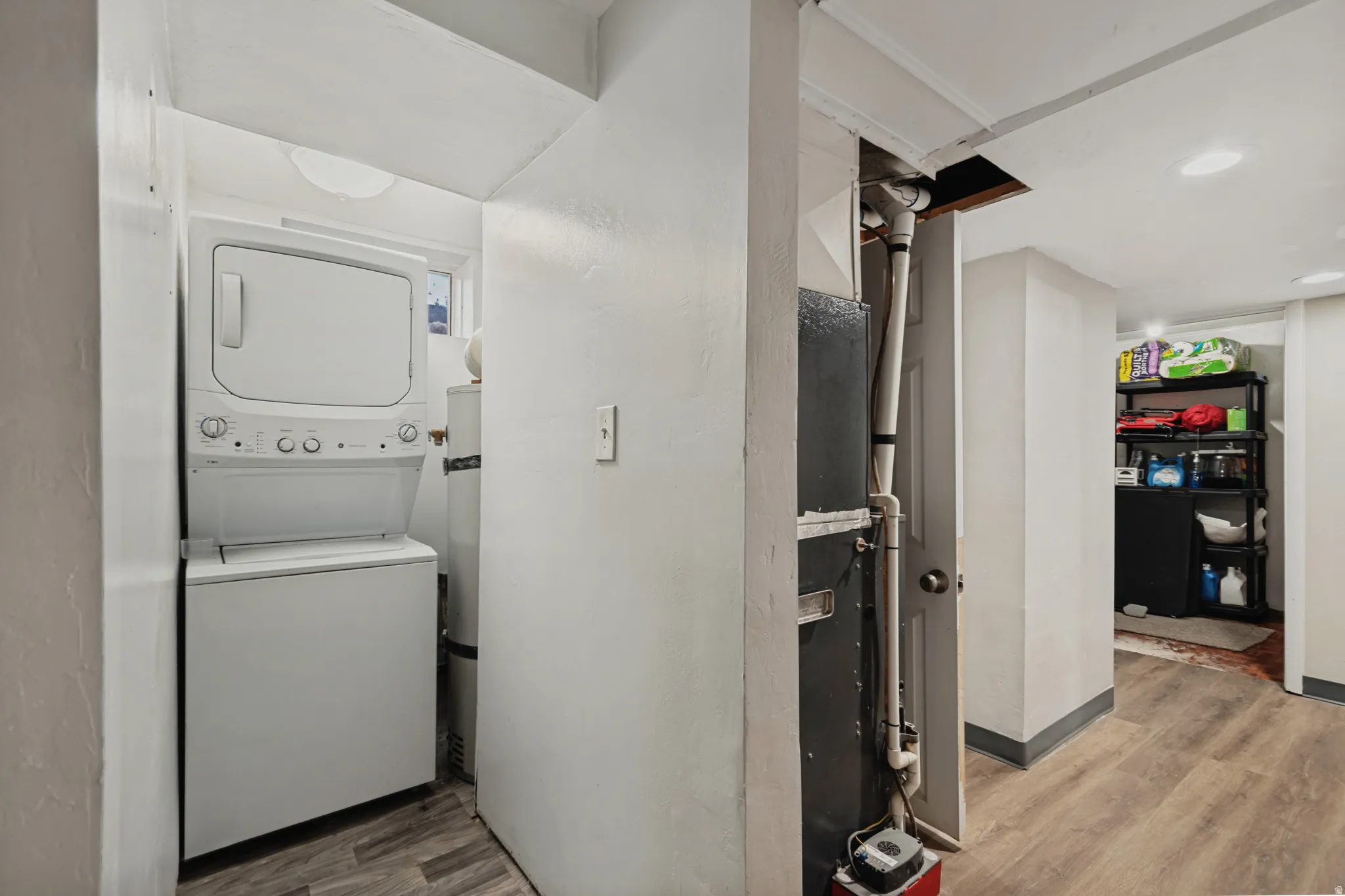 Dedicated laundry area featuring a stacked washer and dryer unit