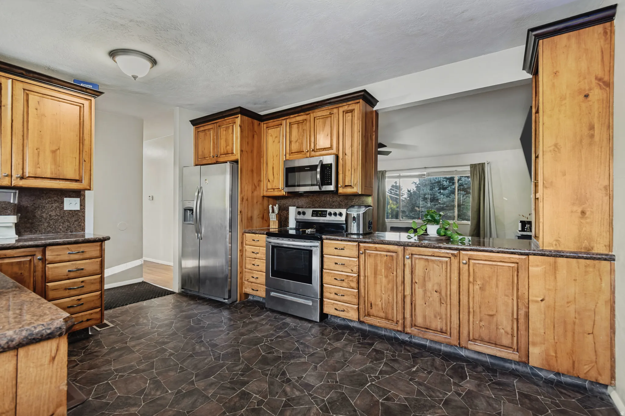 Stainless steel refrigerator, built-in microwave, and electric range
