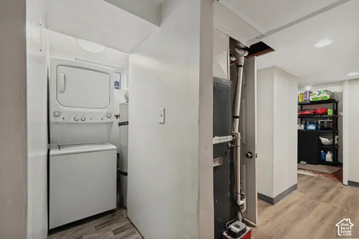 Dedicated laundry area featuring a stacked washer and dryer unit