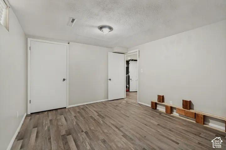 Wood-finish flooring, neutral wall tones, and recessed lighting