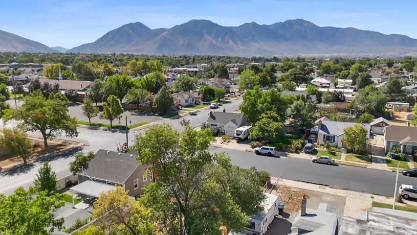 Expansive neighborhood with mature trees and mountain backdrop