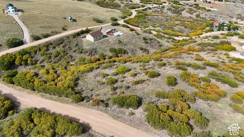 Expansive parcel featuring rolling topography, native vegetation, established gravel road access, and elevated positioning