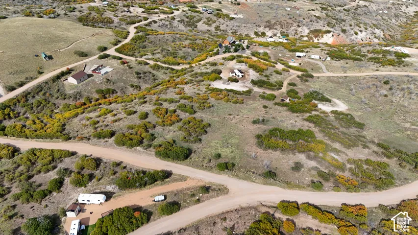 Aerial view of expansive terrain featuring native shrubbery, rolling topography, and unpaved access roads