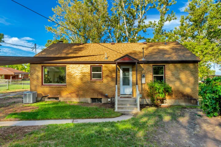 Brick exterior with a gabled roof and front entry porch with steps
