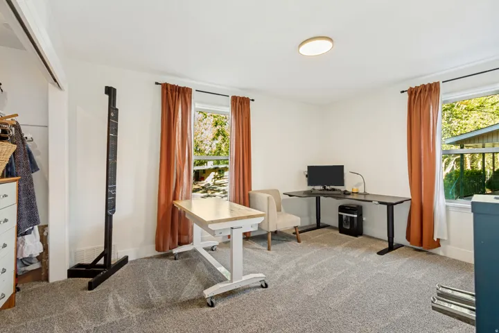 Carpeted room featuring multiple windows, recessed lighting, and a closet with a built-in hanging rod