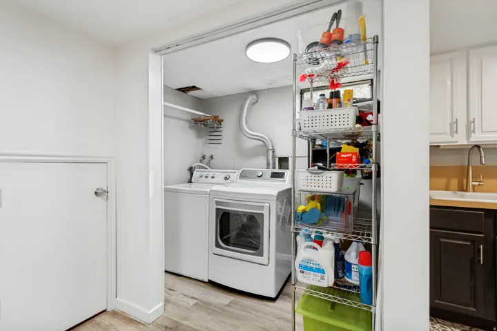 Laundry area with light wood-finish flooring